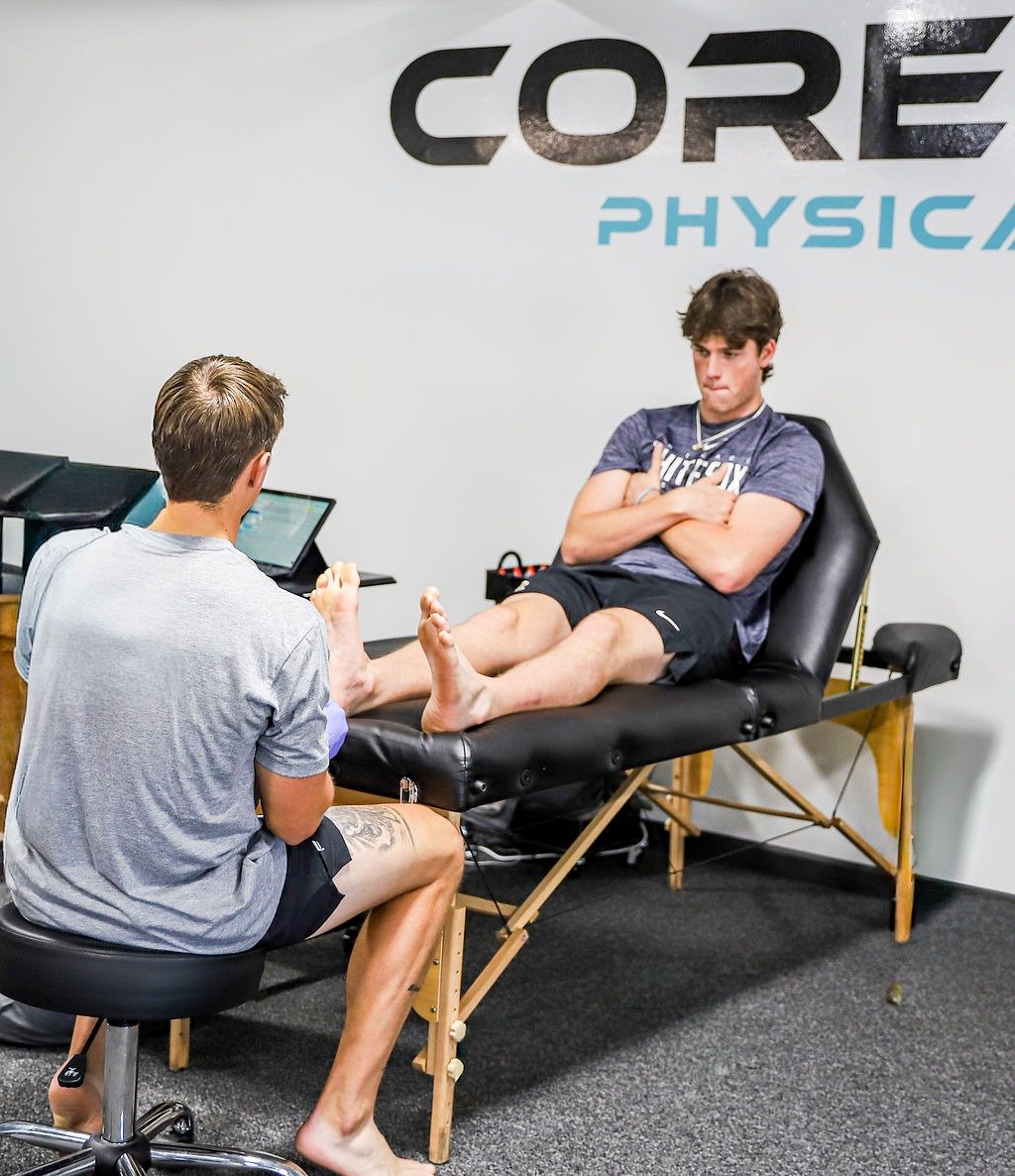 Physical therapist conducting movement assessment with athlete